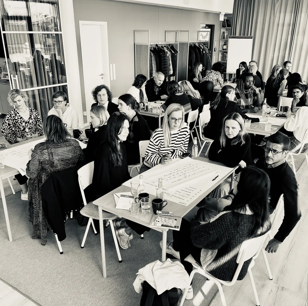 A small group taking part in a collaborative leadership workshop