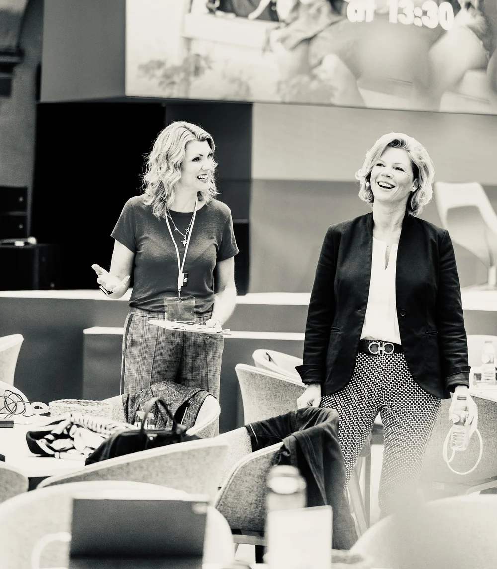 Charlotte sharing a relaxed conversation with another person