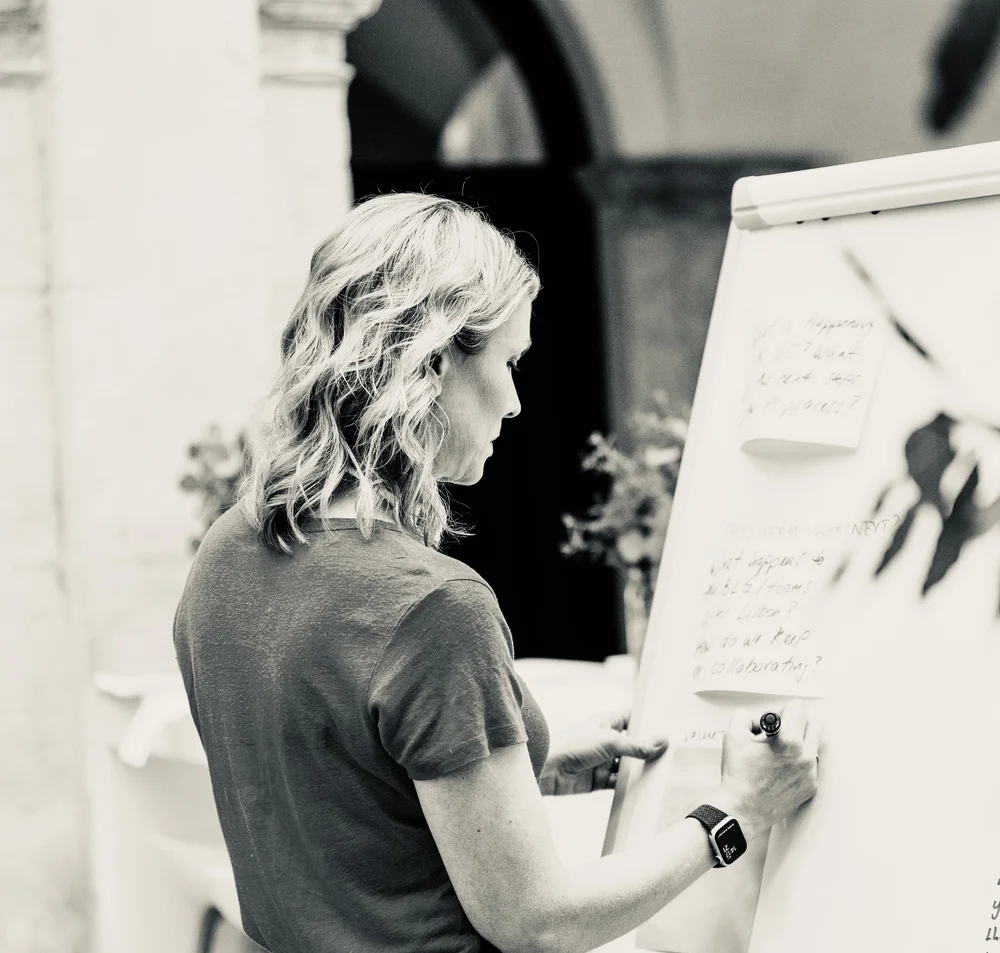 Charlotte working at a flip chart during a facilitated session